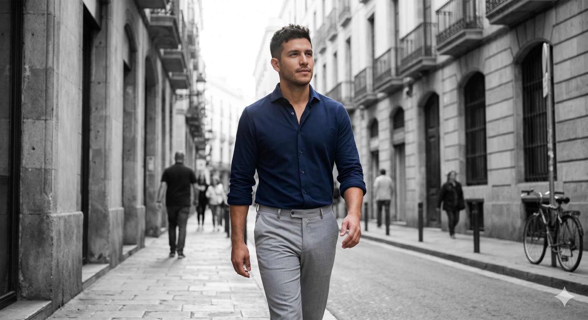 A man in a navy Landivar shirt walking a quiet city street